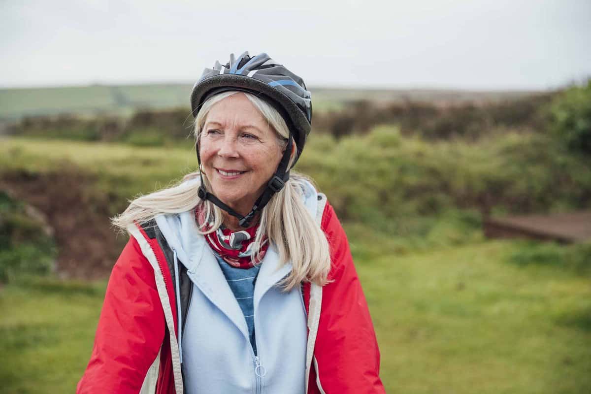 Old woman outside cycling